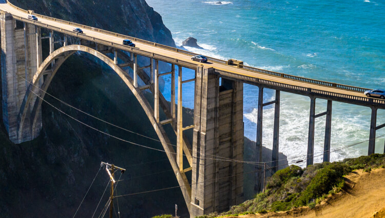 scenic bridge overlooking ocean.